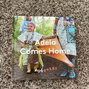 Lovevery board book. Adela comes home. Like new.
